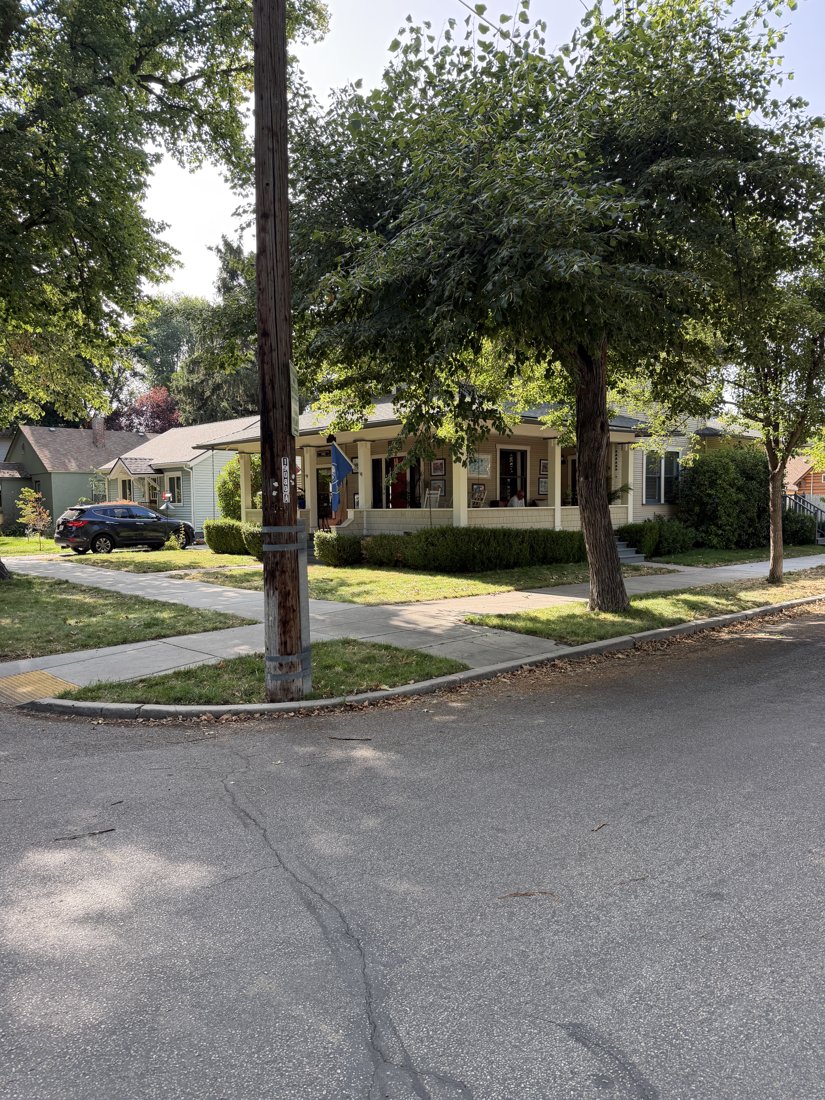 North side, viewed from the south. Jefferson streetscape and front of the two-story house, partly screened by a street tree.