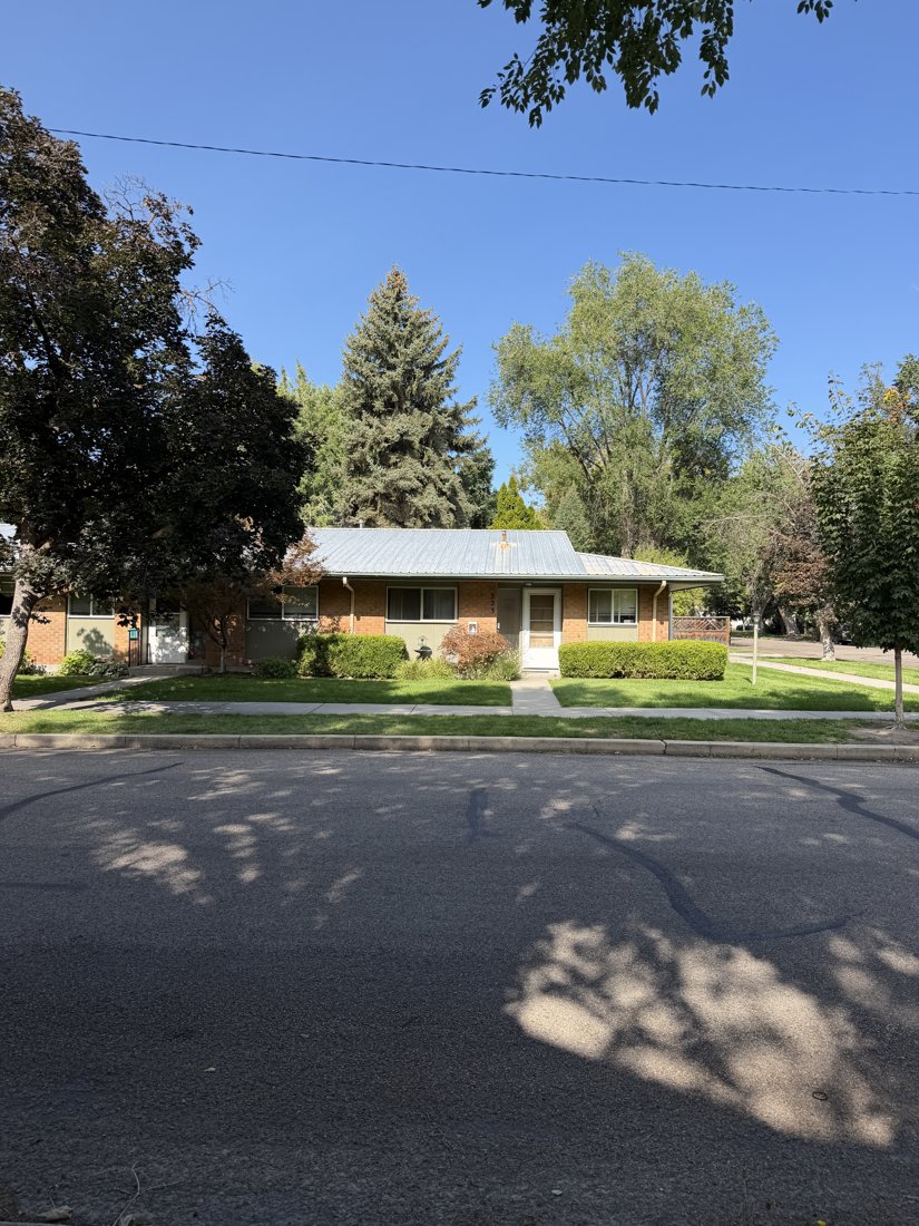 South and east sides, viewed from the northwest. Street elevation of the brick residential group with a doorway and adjacent windows.