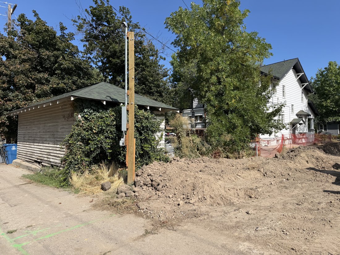 North side, viewed from the south. View of the rear yard and associated building fabric from the service area.