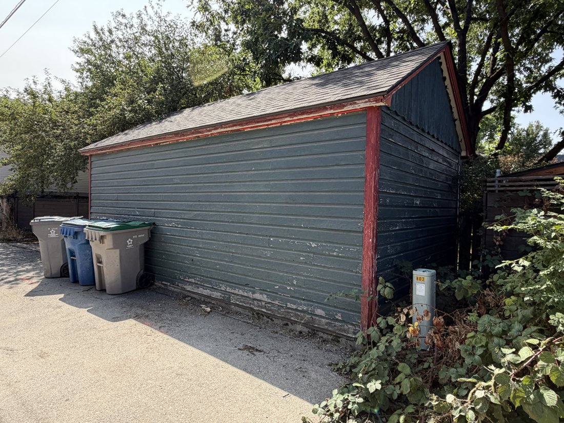 North side, viewed from the northwest. View of the rear yard and associated building fabric from the service area.