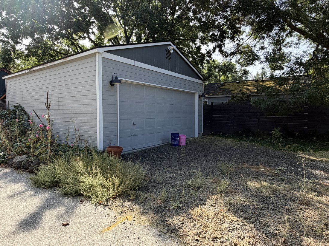 North side, viewed from the north. View of the rear yard and associated building fabric from the service area.