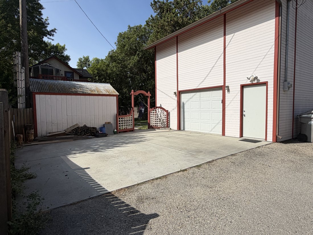 North side, viewed from the northeast. Detached accessory building and alley relationship.