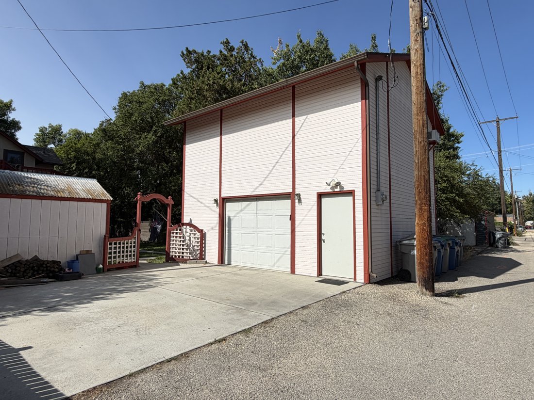 North side, viewed from the northeast. View of the rear yard and associated building fabric from the service area.