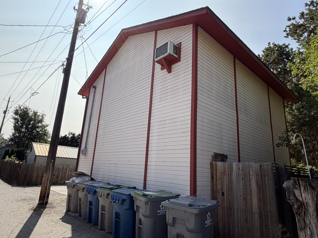 North side, viewed from the northwest. View of the rear yard and associated building fabric from the service area.