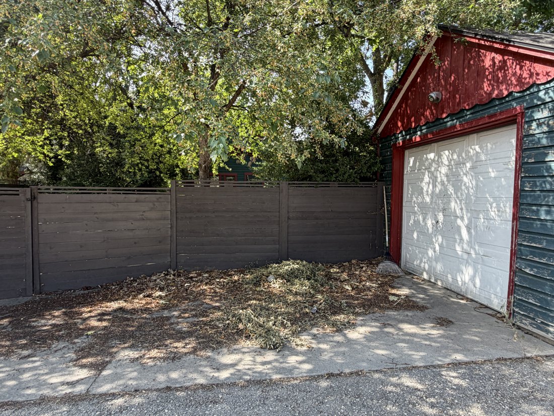 North side, viewed from the north. View of the rear yard and associated building fabric from the service area.