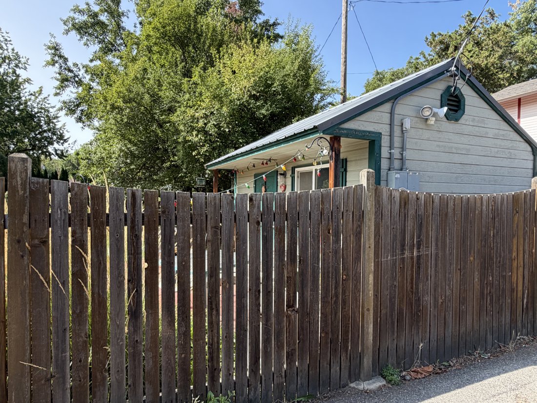 North side, viewed from the northeast. View of the rear yard and associated building fabric from the service area.