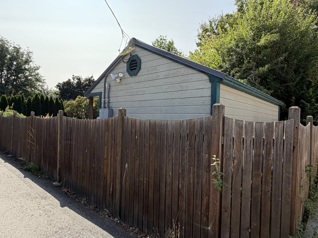 North side, viewed from the northwest. View of the rear yard and associated building fabric from the service area.