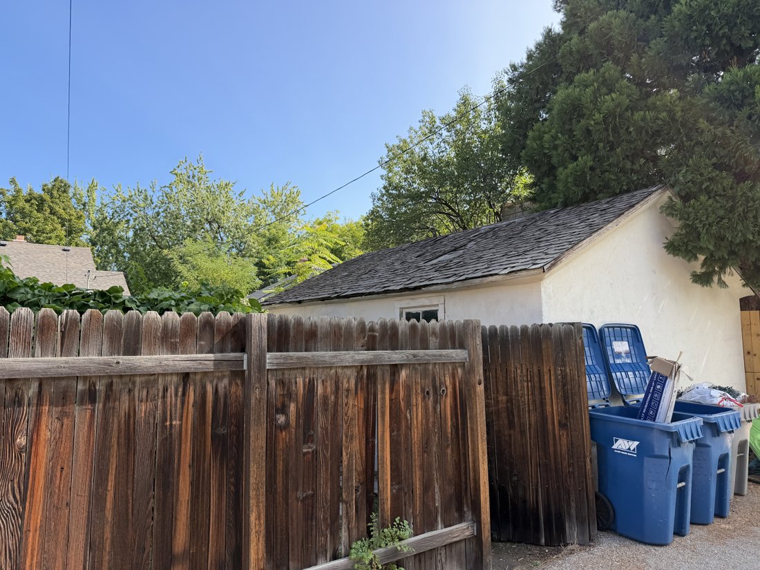 South side, viewed from the northwest. Detached accessory building and alley relationship.