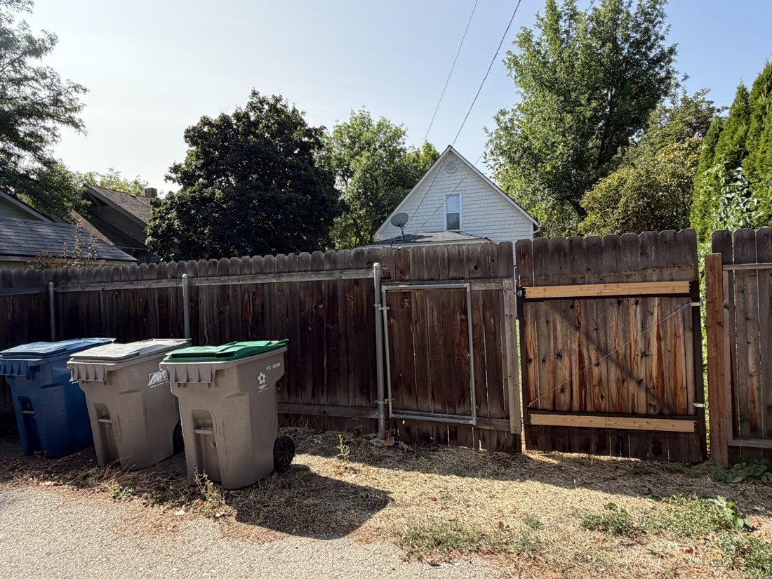 North side, viewed from the north. View of the rear yard and associated building fabric from the service area.